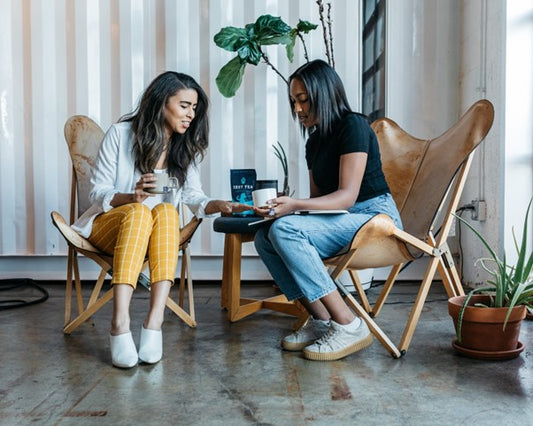 women drinking energy tea at work