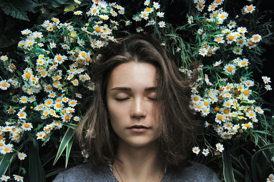 woman sleeping on chamomile flowers