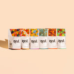 Zest Tea 6-flavor lineup of pouches standing on peach background