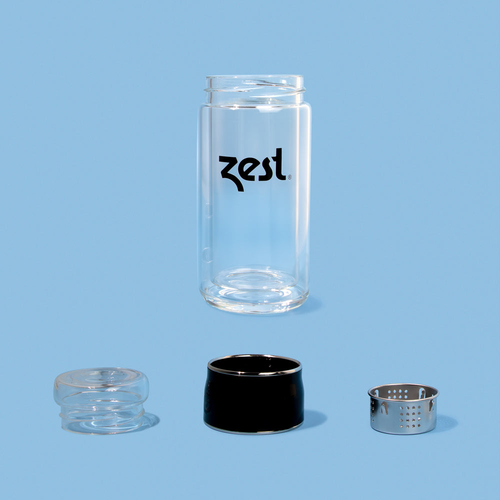 Zest tea infuser bottle disassembled showing glass body lid and steel filter