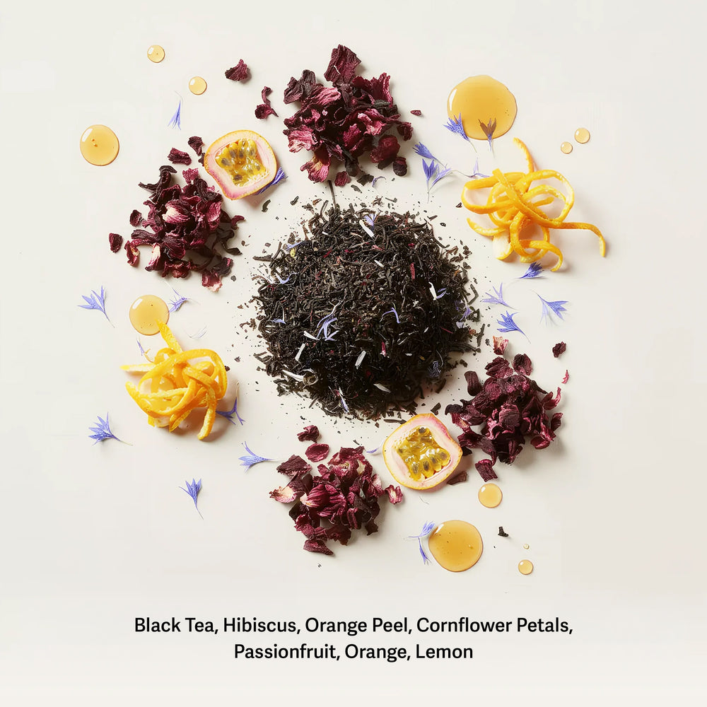Blue Lady tea ingredients flat lay with black tea, hibiscus, orange peel, and passionfruit