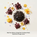 Blue Lady tea ingredients flat lay with black tea, hibiscus, orange peel, and passionfruit