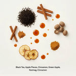 Cinnamon Apple tea ingredients flat lay with black tea, apple, cinnamon sticks, and nutmeg