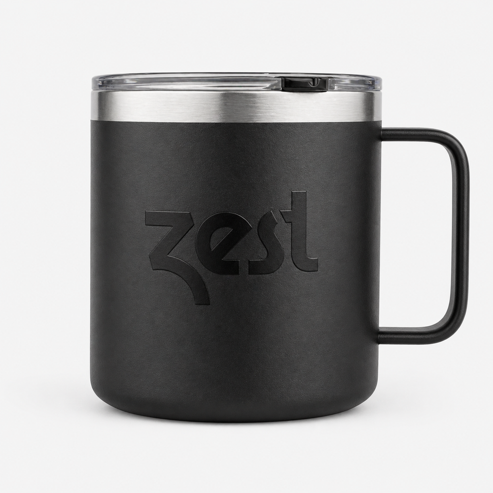 Black mug with silver lid and handle on a white background, featuring the 'Zest' brand.