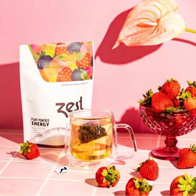 Zest Superberry Samba tea bag steeping in cup with berry accents