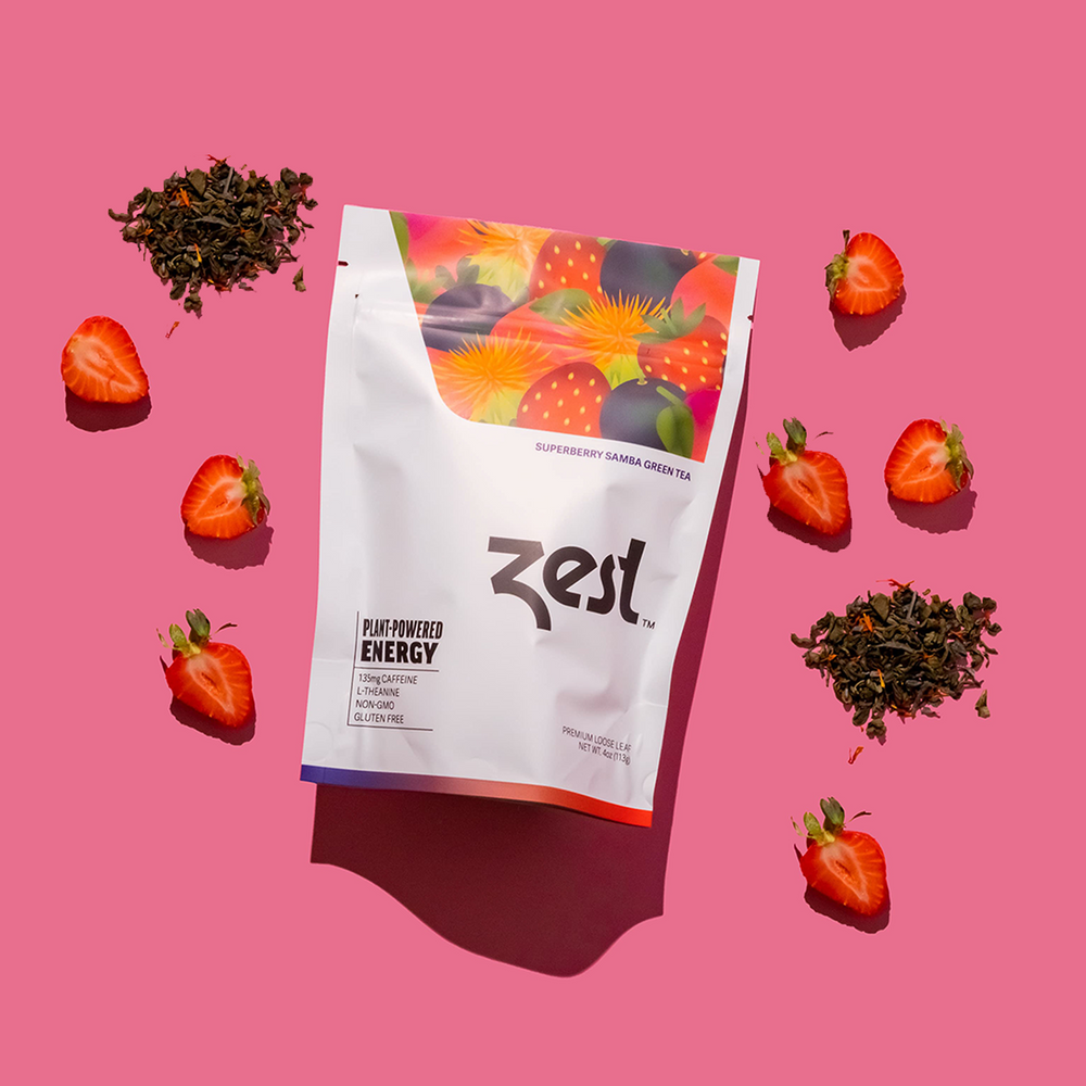 Zest Superberry Samba loose leaf pouch with strawberries and loose tea on pink background