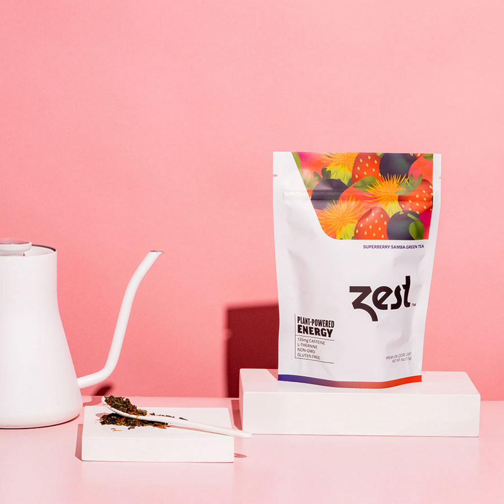Zest Superberry Samba Loose Leaf pouch with gooseneck kettle and loose tea on pink background