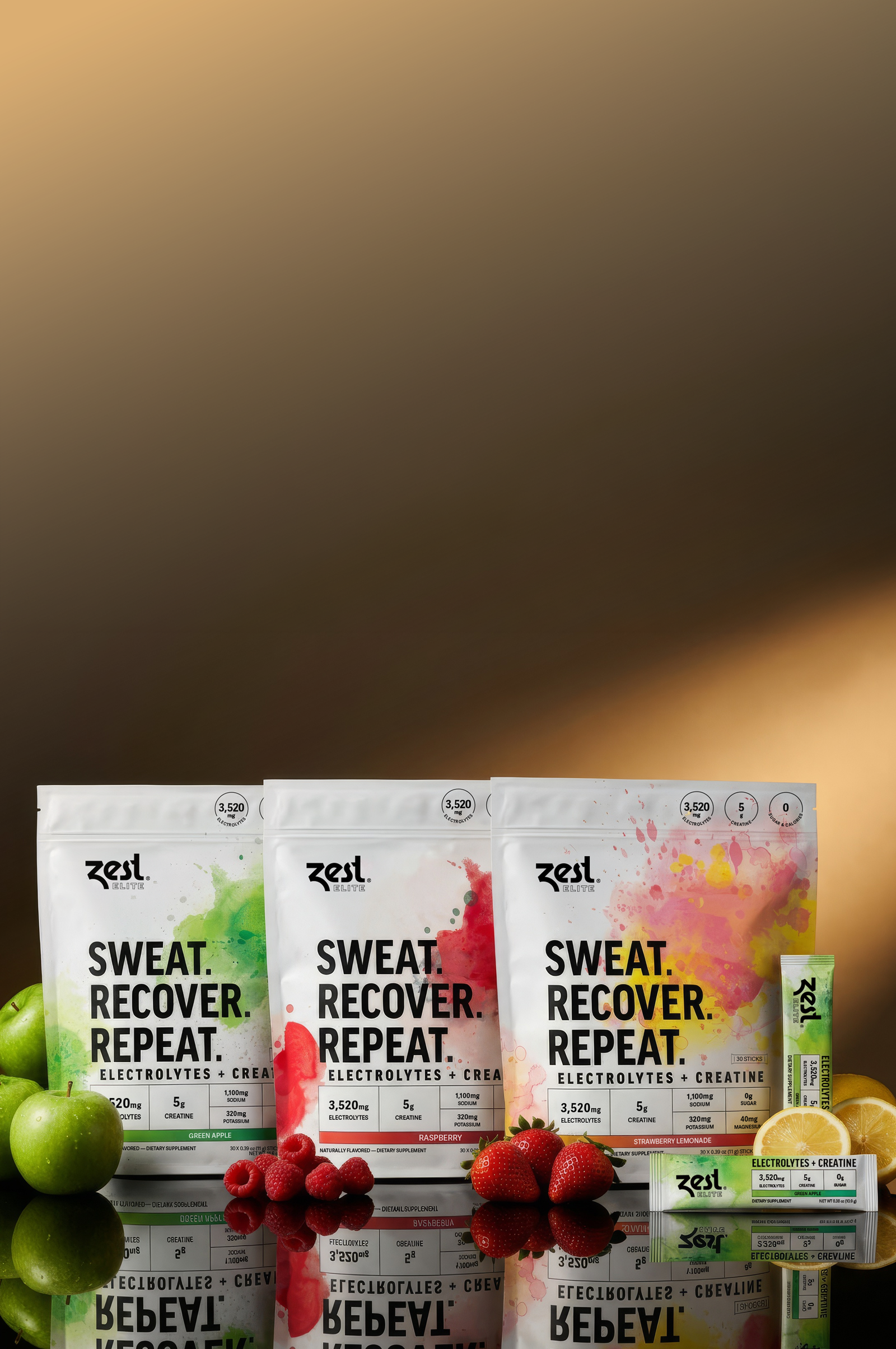 Zest Elite electrolytes and creatine drink mix pouches in Green Apple, Raspberry and Strawberry Lemonade, surrounded by fresh apples, raspberries, strawberries and lemon.